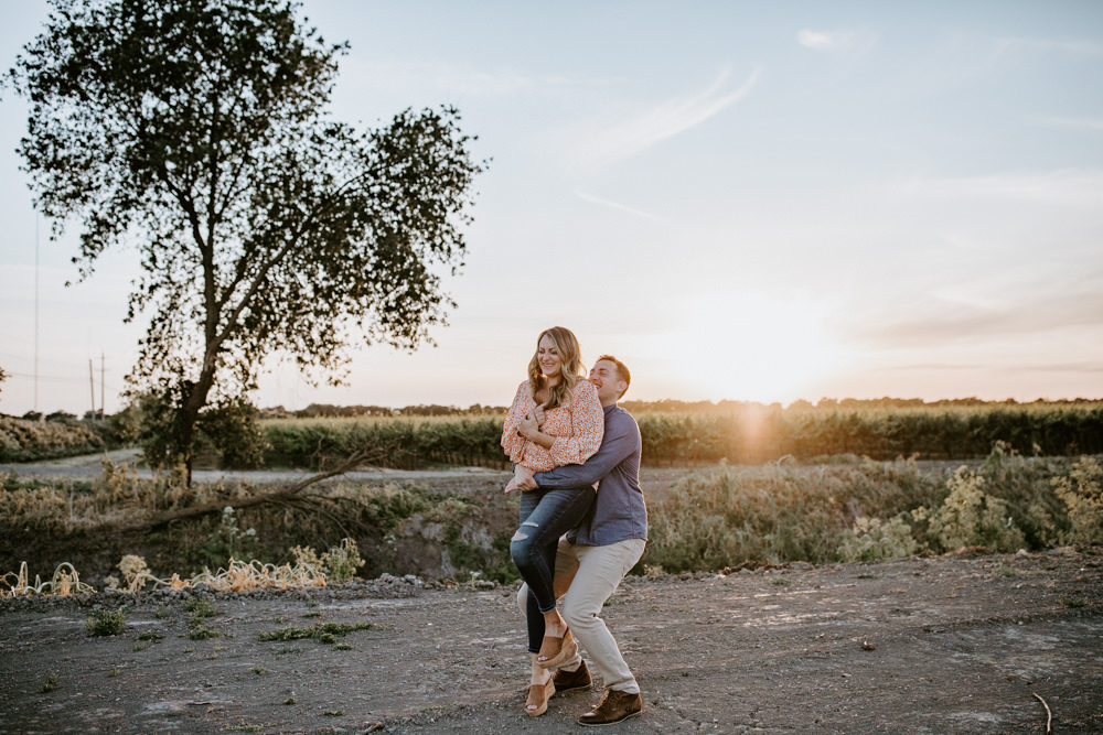 Sacramento River Engagement Session Northern California Weiner dog engagement shoot outfit inspo engagement photos with dog couples shoot posing golden hour sacramento river rachel christopherson photography golden grape fields