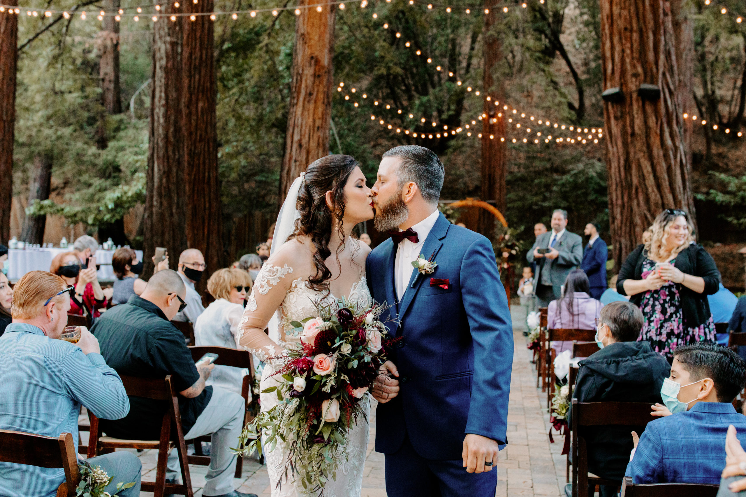 Bride and Groom kissing at end of ceremony walkway in Fairfax California