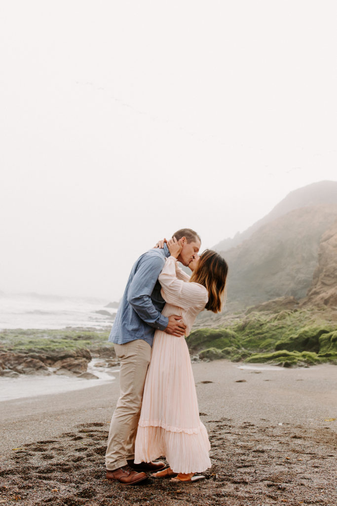couple kissing on bay area beach, Marin Headlands Engagement Photos, Bay Area Engagement Photos, Bay Area Engagement Photo Locations, Engagement Photo Outfits, Bay Area Beach Engagement Photos, Dog Friendly Bay Area Beaches, Best Locations for Bay Area Engagement Photos, San Francisco Engagement Photos, What to Wear for Engagement Photos, Engagement Photos with dogs, Rachel Christopherson Photography LLC