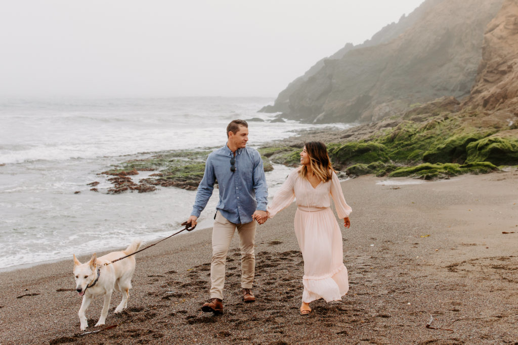 couple walking dog on SF beach, Marin Headlands Engagement Photos, Bay Area Engagement Photos, Bay Area Engagement Photo Locations, Engagement Photo Outfits, Bay Area Beach Engagement Photos, Dog Friendly Bay Area Beaches, Best Locations for Bay Area Engagement Photos, San Francisco Engagement Photos, What to Wear for Engagement Photos, Engagement Photos with dogs, Rachel Christopherson Photography LLC