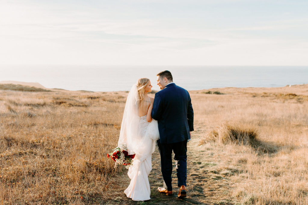 bride and groom walking in field, Mendocino elopement, mendocino wedding, christmas elopement, best places to elope in california, norcal elopement, northern california elopement, elopement inspo, california coast elopement, mendocino california elopement, Rachel Christopherson Photography 