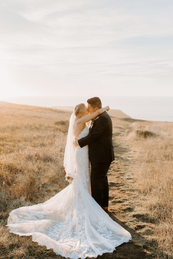 bride and groom kissing in field, Mendocino elopement, mendocino wedding, christmas elopement, best places to elope in california, norcal elopement, northern california elopement, elopement inspo, california coast elopement, mendocino california elopement, Rachel Christopherson Photography 