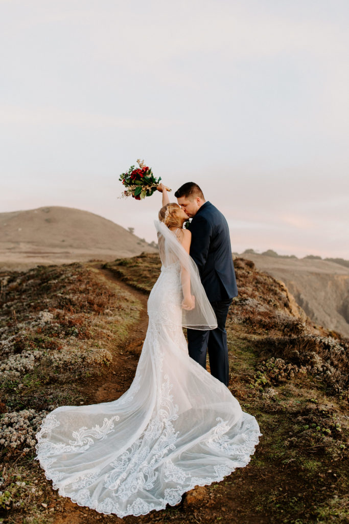 bride and groom kiss on cliff, elopement dress, wedding dress train, Mendocino elopement, mendocino wedding, christmas elopement, best places to elope in california, norcal elopement, northern california elopement, elopement inspo, california coast elopement, mendocino california elopement, Rachel Christopherson Photography 