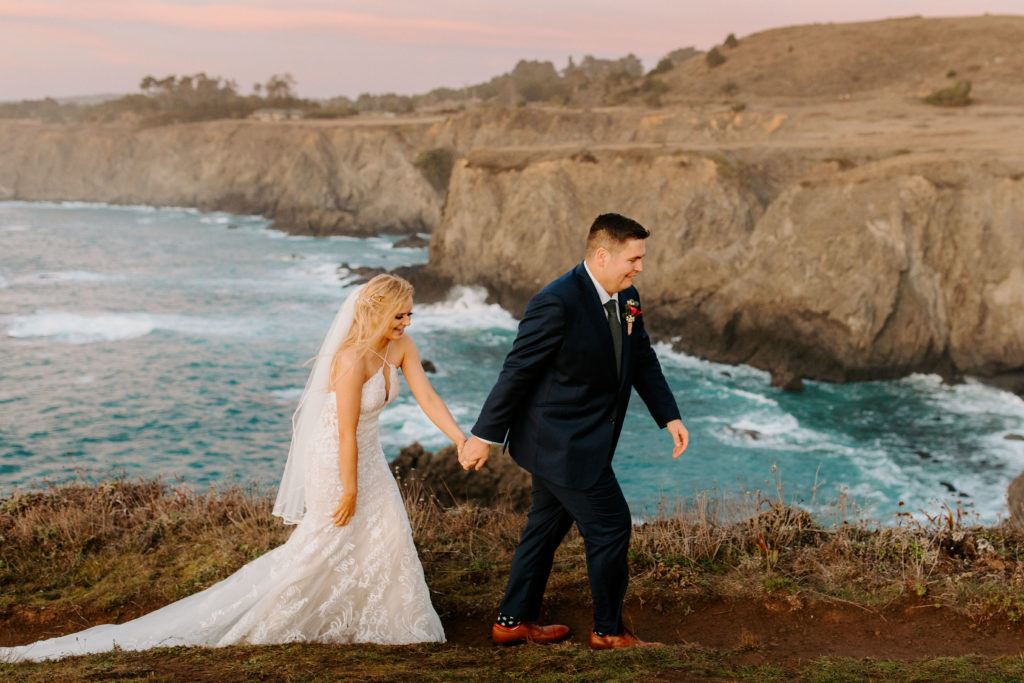 bride and groom walking at sunset on ocean cliff, Mendocino elopement, mendocino wedding, christmas elopement, best places to elope in california, norcal elopement, northern california elopement, elopement inspo, california coast elopement, mendocino california elopement, Rachel Christopherson Photography 