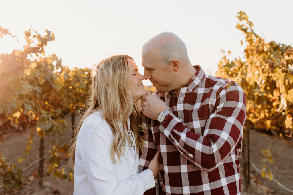couple walking in golden vineyard, vineyard engagement photos, Sacramento engagement photos, sacramento engagement, sacramento engagement photographer sacramento engagement photo locations, sacramento wedding photographer, rachel christopherson photography, engagement photo outfit inspo