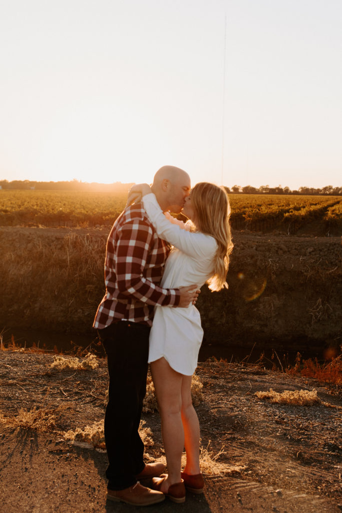 couple kissing during sunset, vineyard engagement photos, Sacramento engagement photos, sacramento engagement, sacramento engagement photographer sacramento engagement photo locations, sacramento wedding photographer, rachel christopherson photography, engagement photo outfit inspo