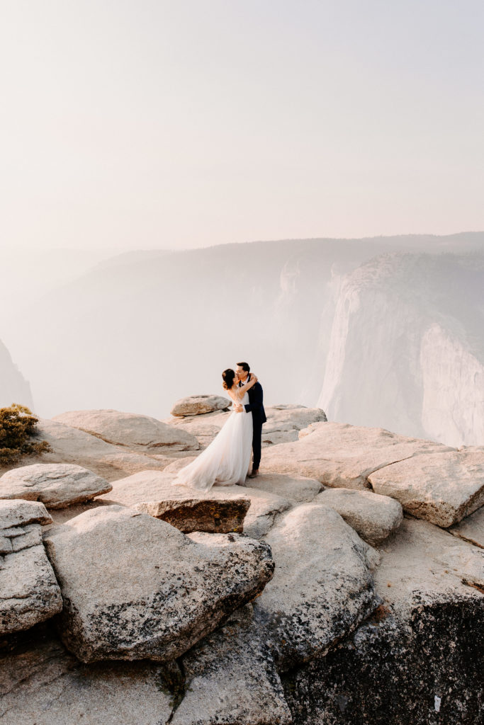 Wide shot of Bride and groom at Taft Point,, Taft Point elopement, Yosemite Elopement, Glacier Point Elopement, best places to elope in california, northern california elopement, Rachel Christopherson Photography