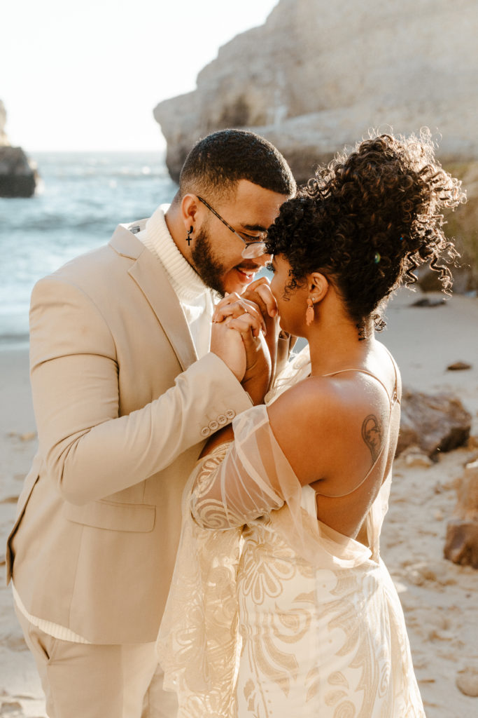 husband kissing wifes hand, Santa cruz wedding, santa cruz elopement, santa cruz wedding photographer, santa cruz elopement photographer, big sur elopement, boho beach bride, california boho elopement, boho wedding dress, best places to elope in California, California elopement, California beach elopement, boho bride inspo, Rachel Christopherson Photography