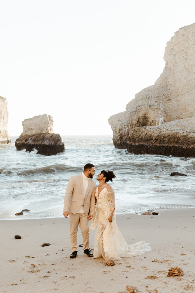 bride and groom walking on beach, Santa cruz wedding, santa cruz elopement, santa cruz wedding photographer, santa cruz elopement photographer, big sur elopement, boho beach bride, california boho elopement, boho wedding dress, best places to elope in California, California elopement, California beach elopement, boho bride inspo, Rachel Christopherson Photography