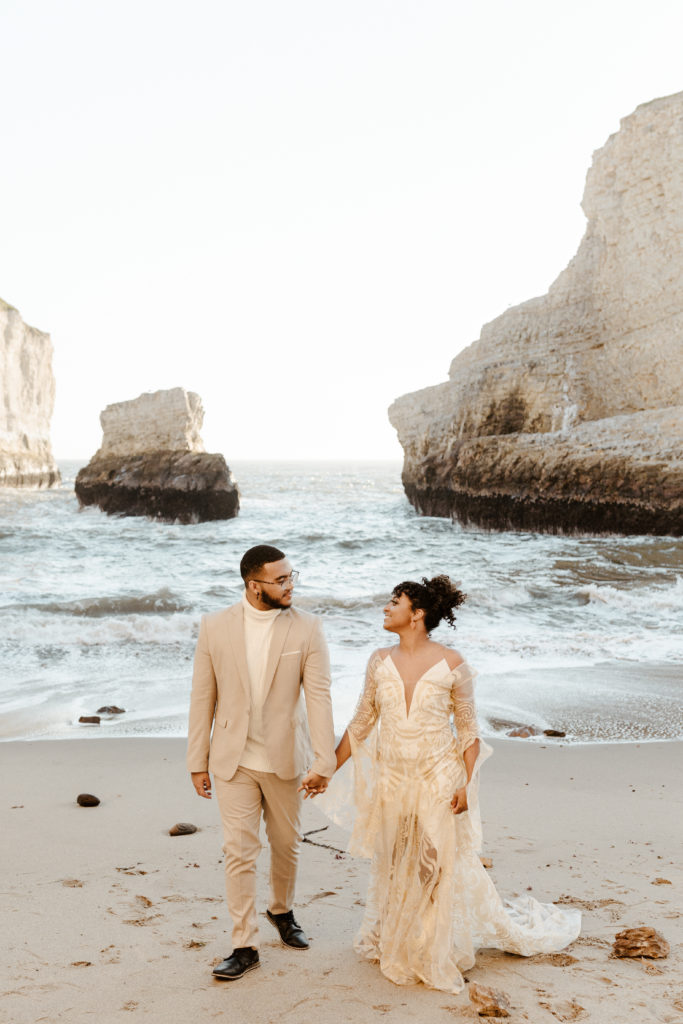 bride and groom walking on beach, Santa cruz wedding, santa cruz elopement, santa cruz wedding photographer, santa cruz elopement photographer, big sur elopement, boho beach bride, california boho elopement, boho wedding dress, best places to elope in California, California elopement, California beach elopement, boho bride inspo, Rachel Christopherson Photography