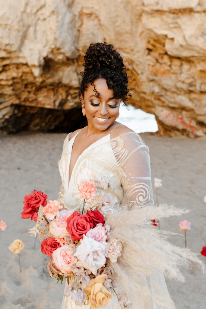bride looking at flowers, Santa cruz wedding, santa cruz elopement, santa cruz wedding photographer, santa cruz elopement photographer, big sur elopement, boho beach bride, california boho elopement, boho wedding dress, best places to elope in California, California elopement, California beach elopement, boho bride inspo, Rachel Christopherson Photography