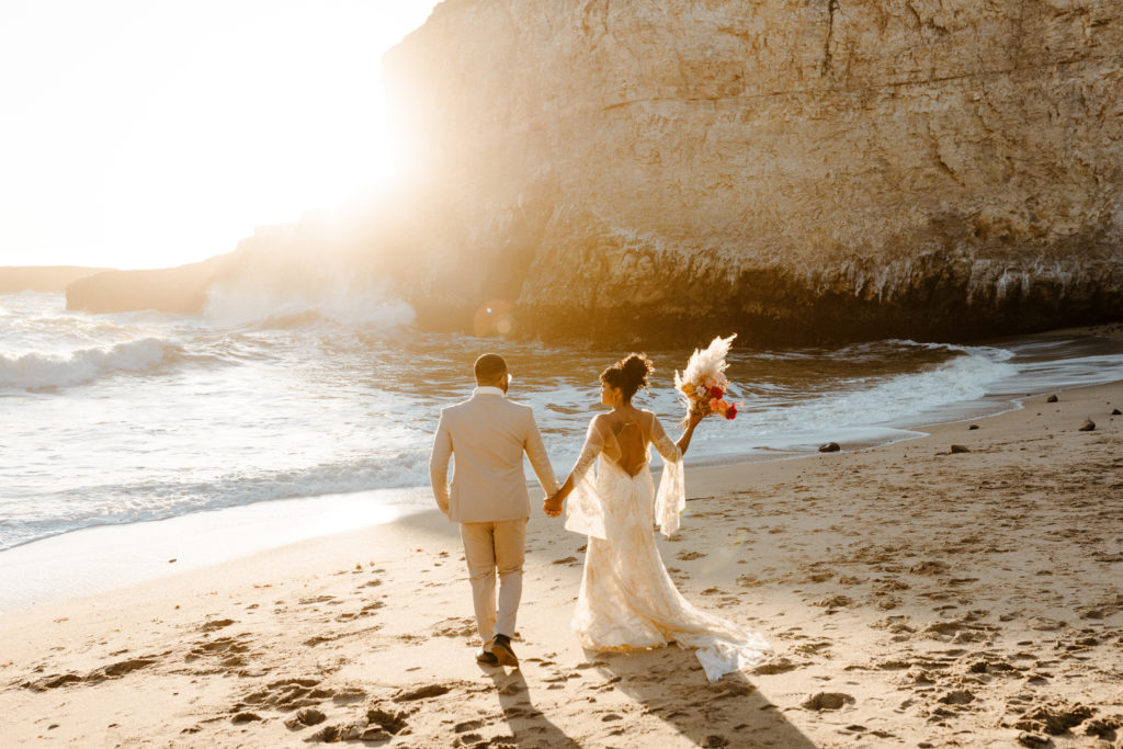 bride and groom walking towards ocean, Santa cruz wedding, santa cruz elopement, santa cruz wedding photographer, santa cruz elopement photographer, big sur elopement, boho beach bride, california boho elopement, boho wedding dress, best places to elope in California, California elopement, California beach elopement, boho bride inspo, Rachel Christopherson Photography