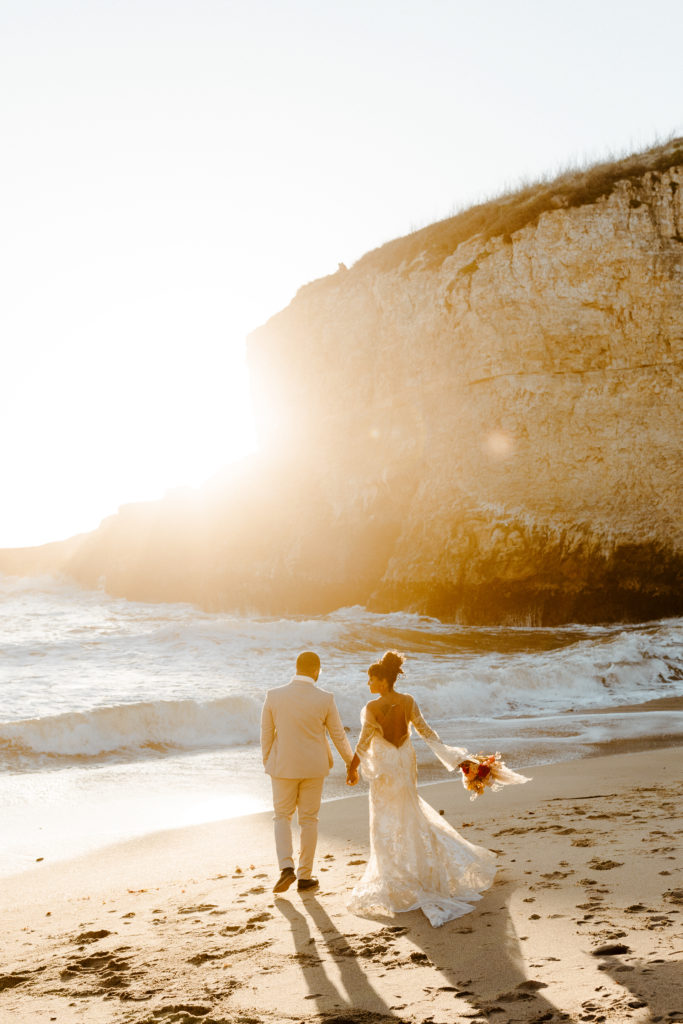 bride and groom walking towards ocean, Santa cruz wedding, santa cruz elopement, santa cruz wedding photographer, santa cruz elopement photographer, big sur elopement, boho beach bride, california boho elopement, boho wedding dress, best places to elope in California, California elopement, California beach elopement, boho bride inspo, Rachel Christopherson Photography