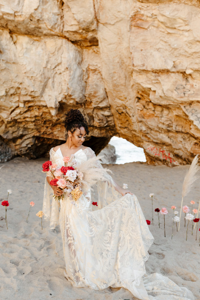 bride looking at flowers, Santa cruz wedding, santa cruz elopement, santa cruz wedding photographer, santa cruz elopement photographer, big sur elopement, boho beach bride, california boho elopement, boho wedding dress, best places to elope in California, California elopement, California beach elopement, boho bride inspo, Rachel Christopherson Photography