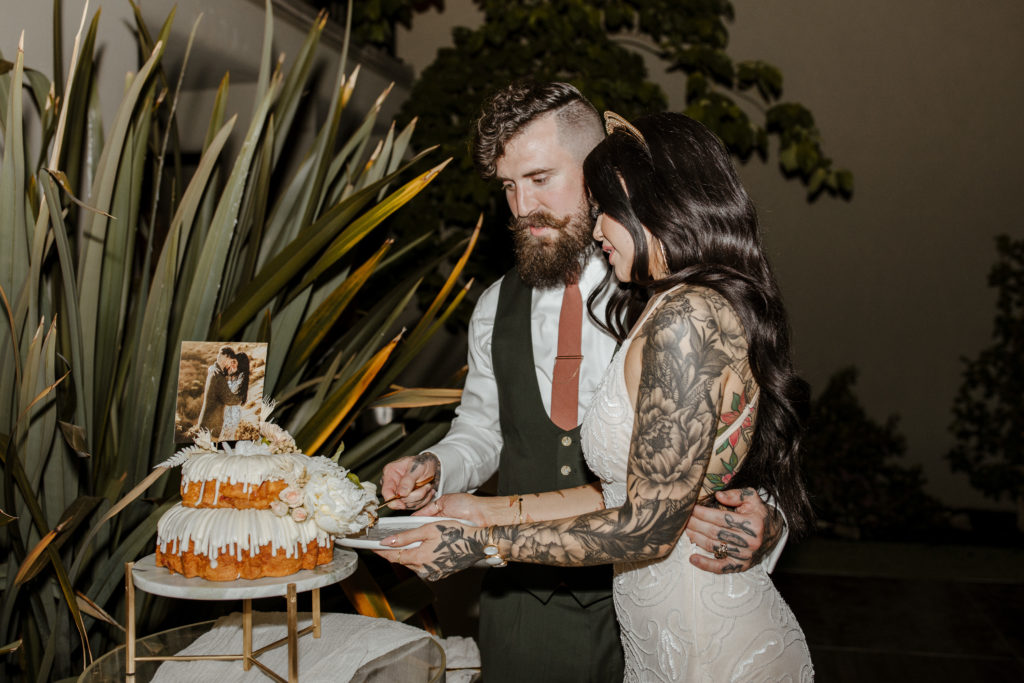 Rachel Christopherson Photography-Backyard Wedding-Unique Wedding Arch-Boho Wedding-Boho Bride-Edgy Wedding-Tattooed Bride-Tattooed Groom-Lake Tahoe Wedding-Northern California Wedding-Nor Cal Wedding-Sacramento-Lake Tahoe-Monterey-Carmel-Santa Cruz-Big Sur-Yosemite-Mendocino-Wedding and Elopement Photographer-Wedding Details-Wedding Reception Cake Cutting