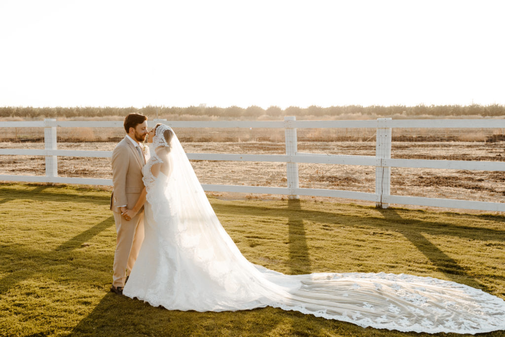 rachelchristophersonphotography-northern califorrnia wedding-traditional wedding-nor cal wedding-traditional ceremony-northern california wedding photographer-sacramento wedding-sacramento wedding photographer-ranch wedding-golden hour-lacey wedding dress-beige grooms suit-long train veil-bridal veil