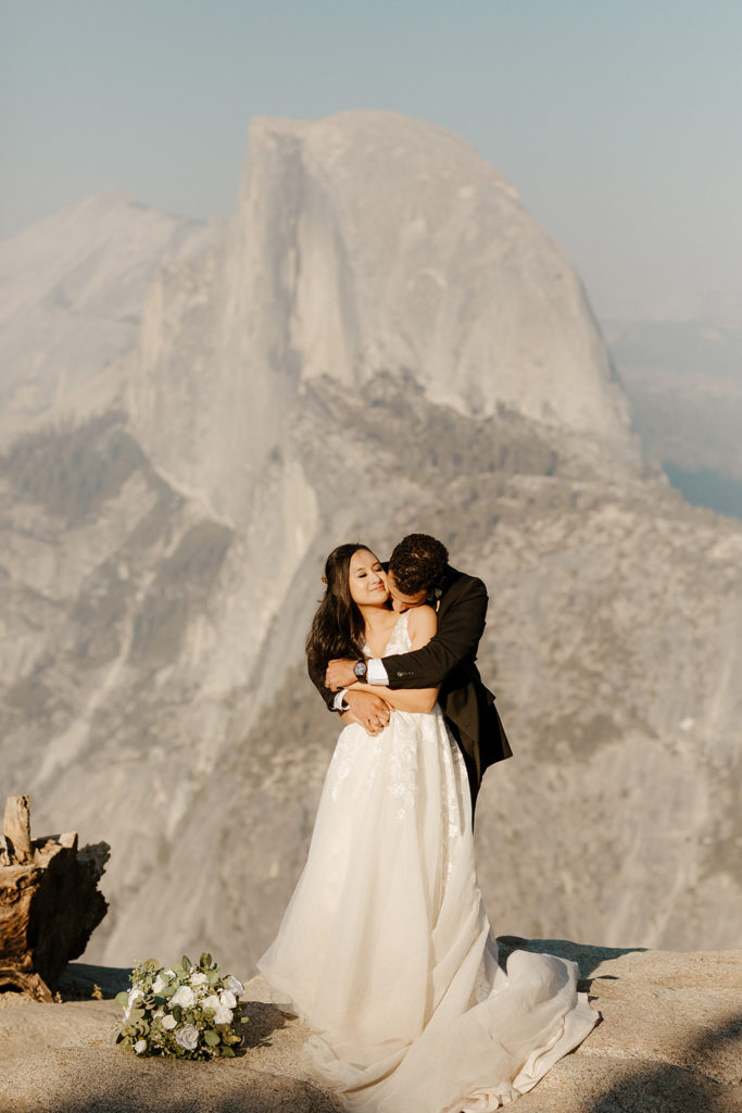 rachelchristophersonphotos-glacier point yosemite elopement-yosemite elopement-glacier point elopement-mountain top elopement-northern california elopement-bride and groom-slick black suit-lacey floral wedding gown