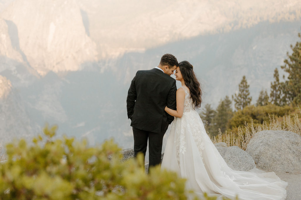 rachelchristophersonphotos-glacier point yosemite elopement-yosemite elopement-glacier point elopement-mountain top elopement-northern california elopement-bride and groom-slick black suit-lacey floral wedding gown