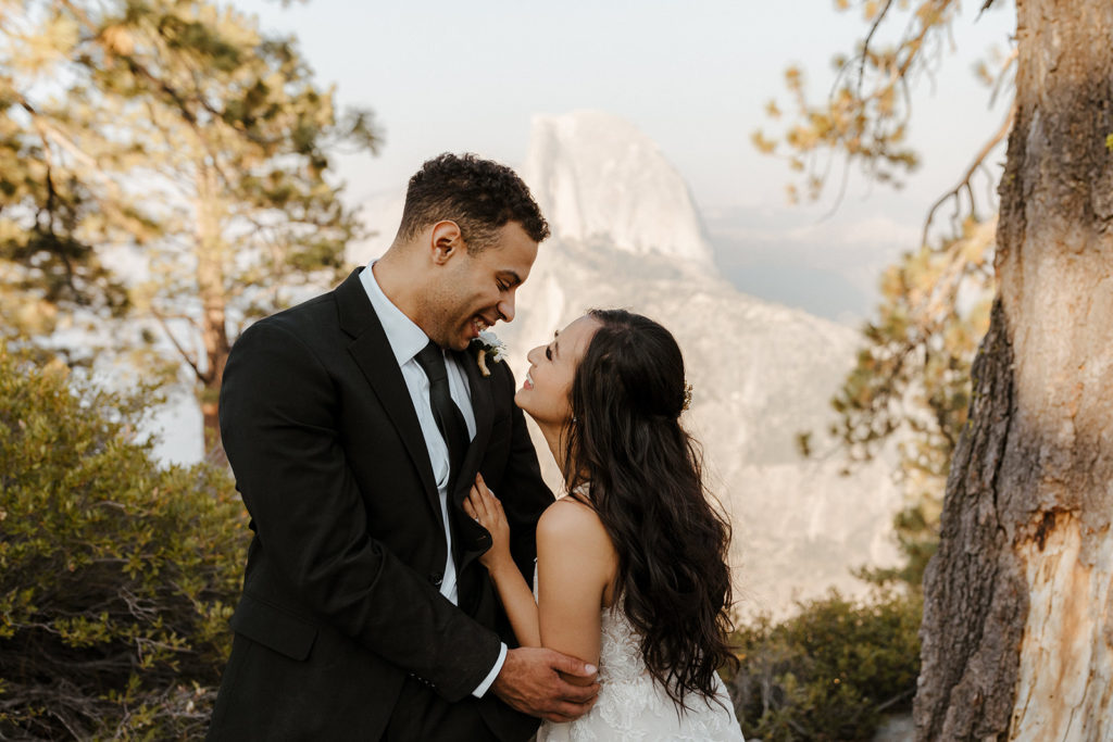rachelchristophersonphotos-glacier point yosemite elopement-yosemite elopement-glacier point elopement-mountain top elopement-northern california elopement-bride and groom-slick black suit-lacey floral wedding gown