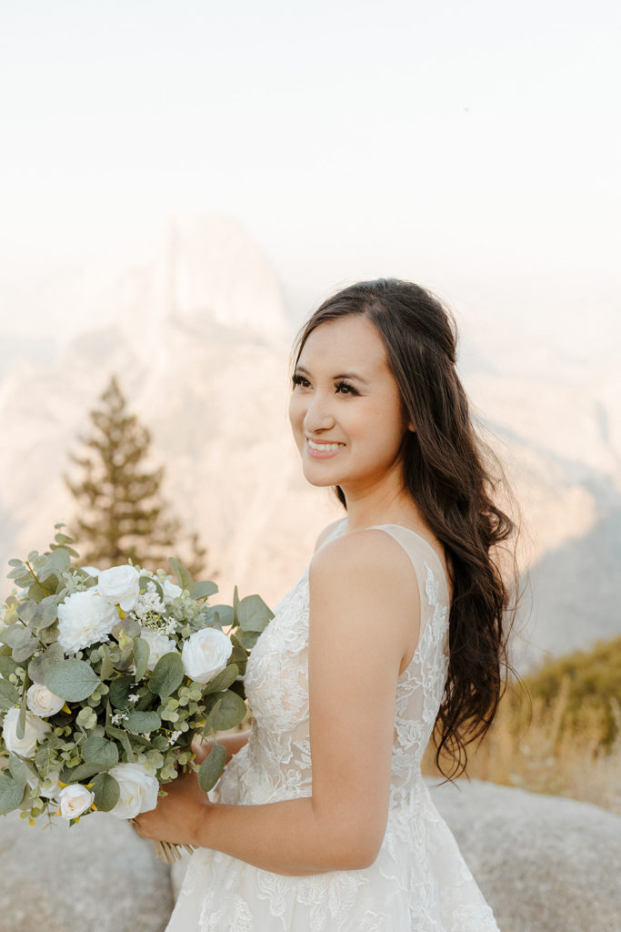 rachelchristophersonphotos-glacier point yosemite elopement-yosemite elopement-glacier point elopement-mountain top elopement-northern california elopement-bride and groom-slick black suit-lacey floral wedding gown