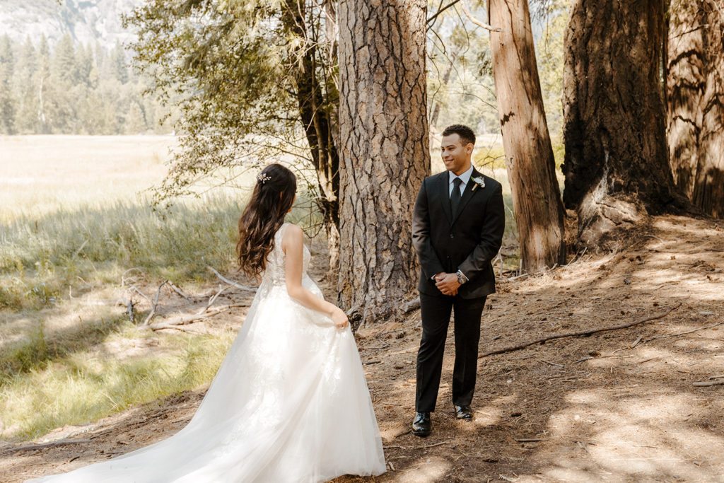 rachelchristophersonphotos-swinging bridge-yosemite elopement-yosemite elopement-swinging bridge elopement-mountain top elopement-northern california elopement-bride and groom-slick black suit-lacey floral wedding gown-bride and groom first look-first look photos