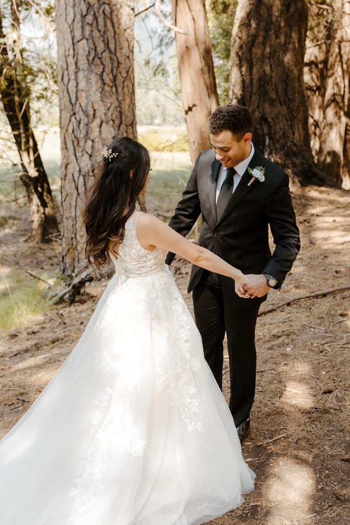 rachelchristophersonphotos-swinging bridge-yosemite elopement-yosemite elopement-swinging bridge elopement-mountain top elopement-northern california elopement-bride and groom-slick black suit-lacey floral wedding gown-bride and groom first look-first look photos