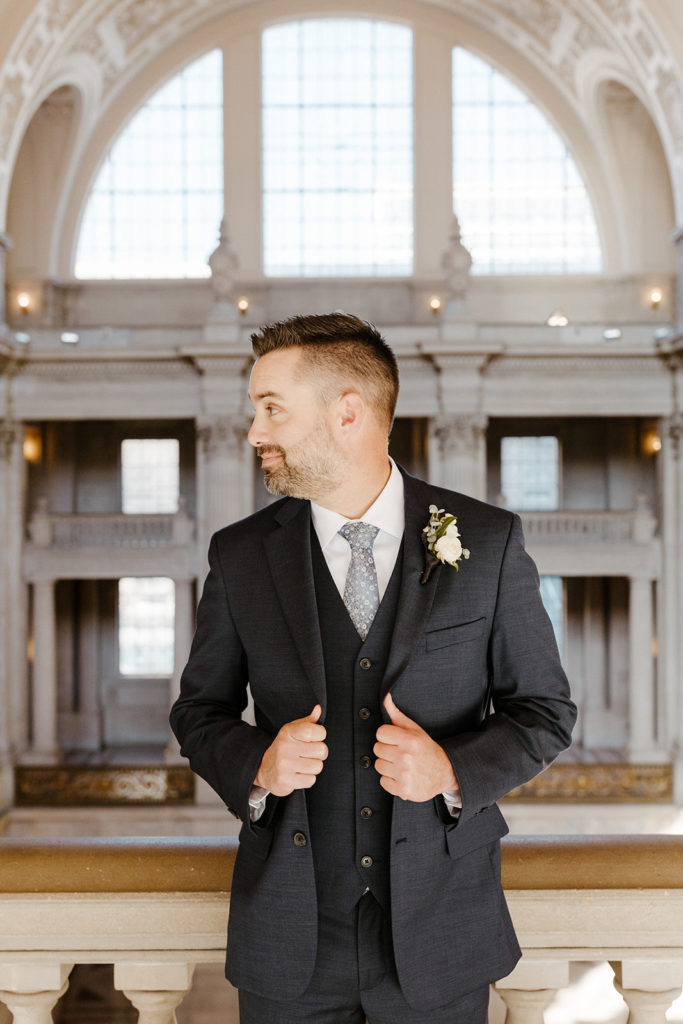 Rachel Christopherson Photographer-SF, San Francisco city hall elopement, san francisco wedding, bride and groom walking down stairs, candid wedding portraits, groom portrait, gray grooms suit
