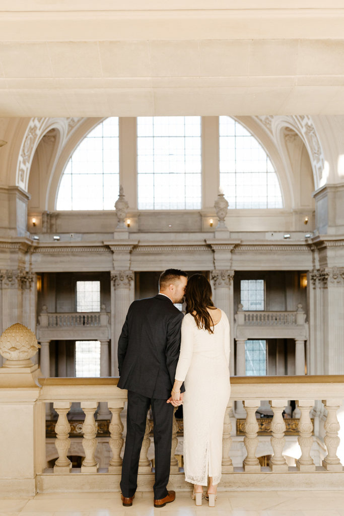 Rachel Christopherson Photographer-SF, San Francisco city hall elopement, san francisco wedding, bride and groom portrait, groom kissing bride cheek, ivory wedding dress, gray grooms suit