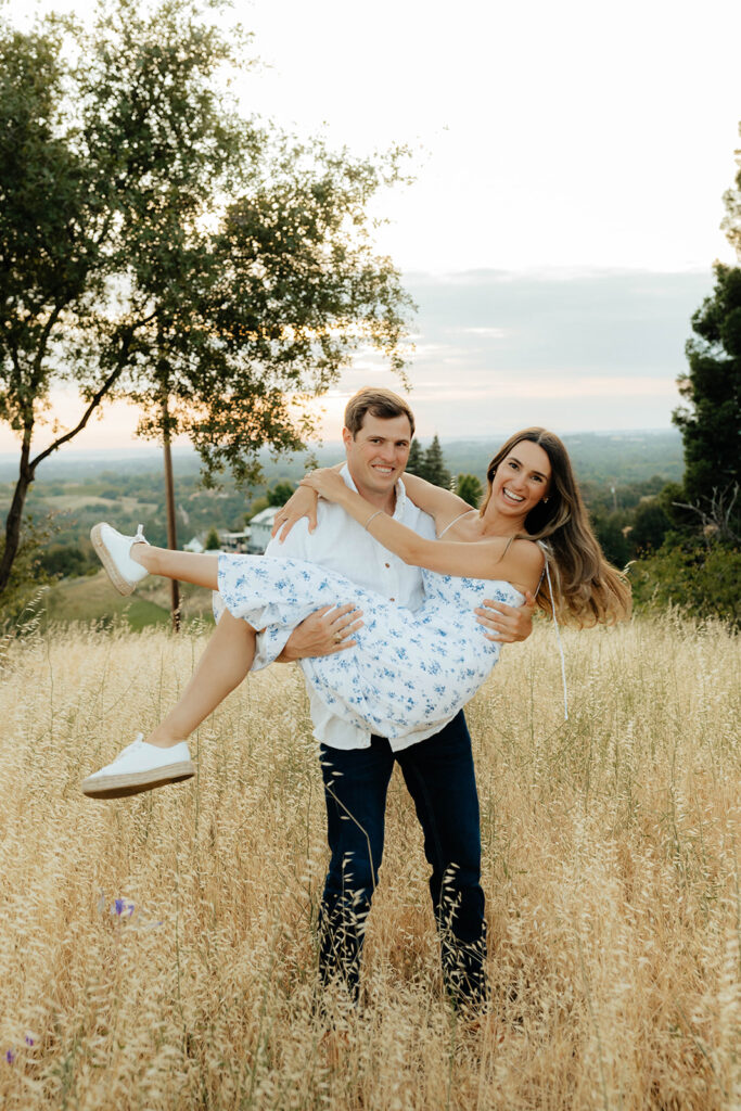 Couple posing for romantic field engagement photos in Auburn, California