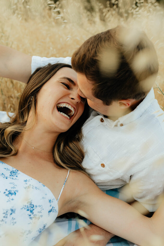 Couple posing for romantic field engagement photos in Auburn, California