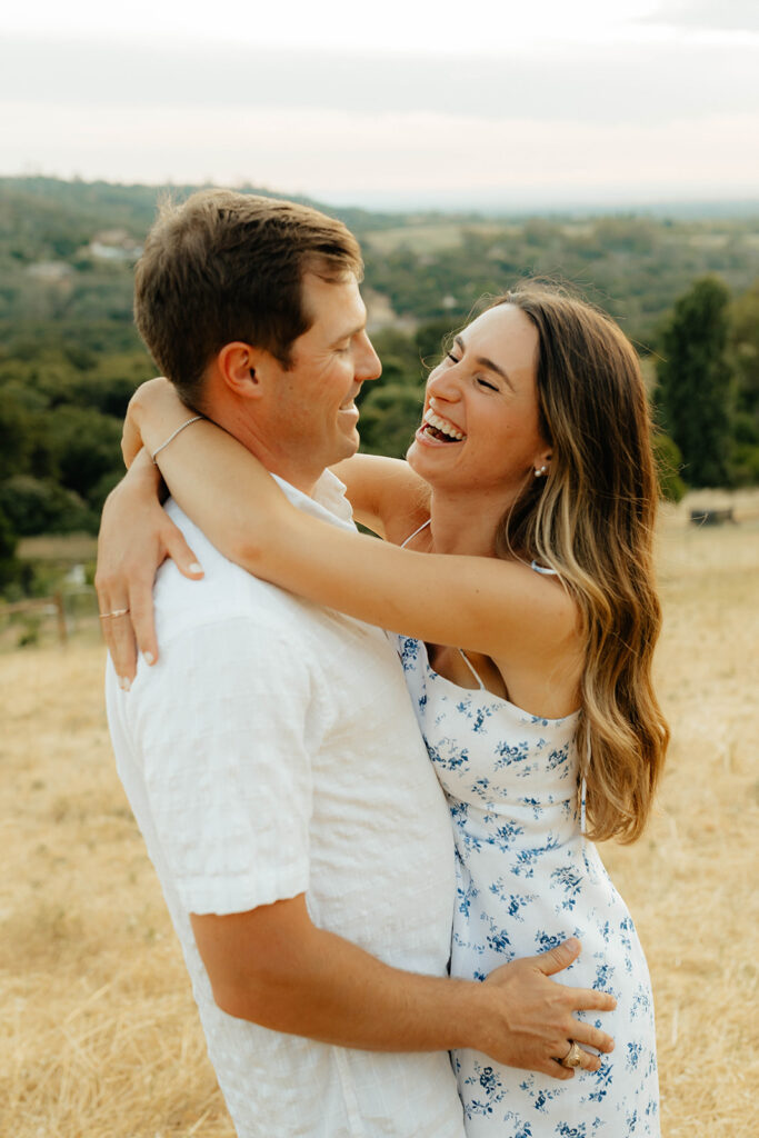 Couple posing for romantic field engagement photos in Auburn, California