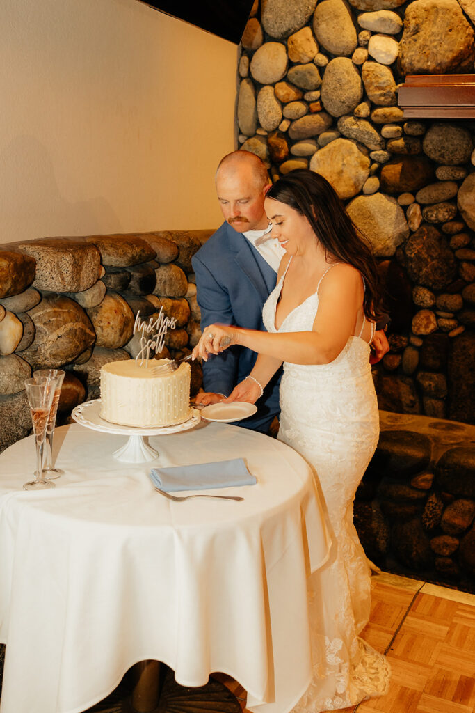 Bride and groom cutting wedding cake