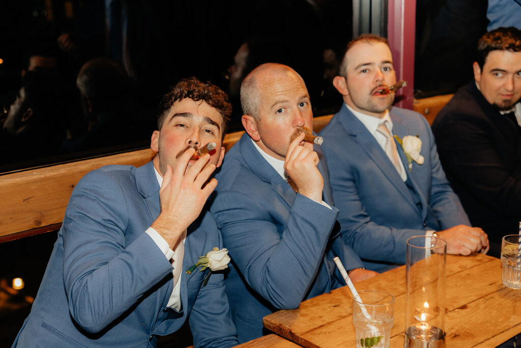Groom and groomsmen smoking cigars