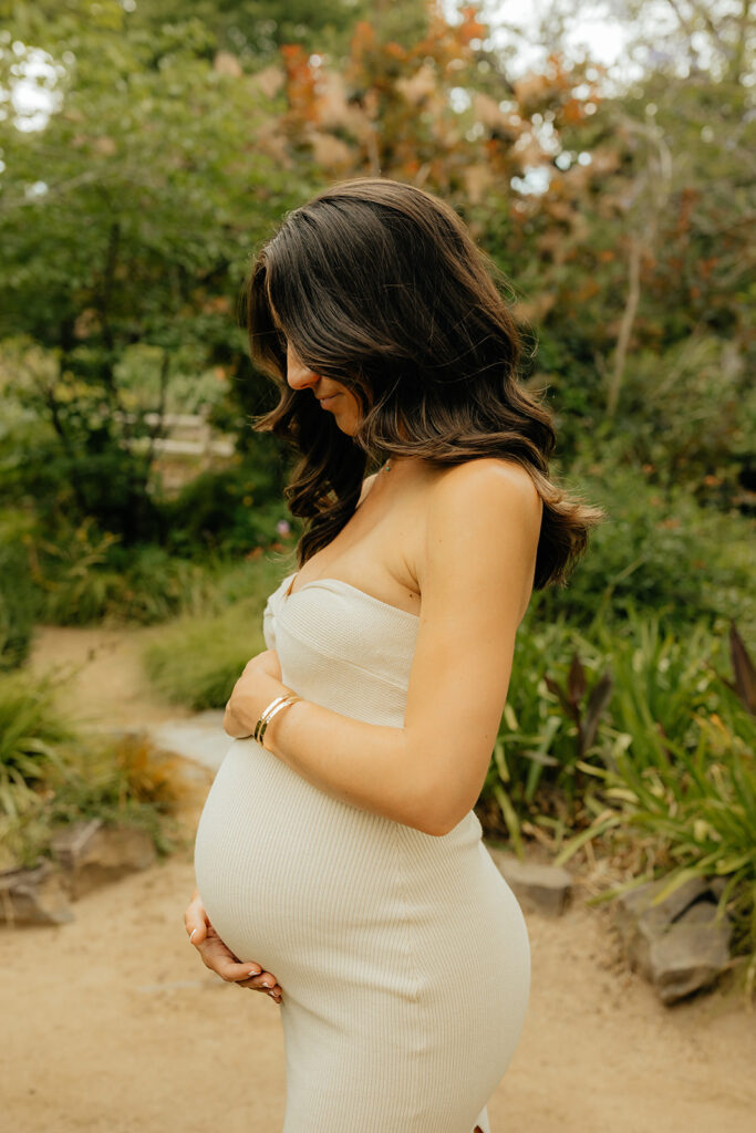 Pregnant mother holding her belly for photoshoot