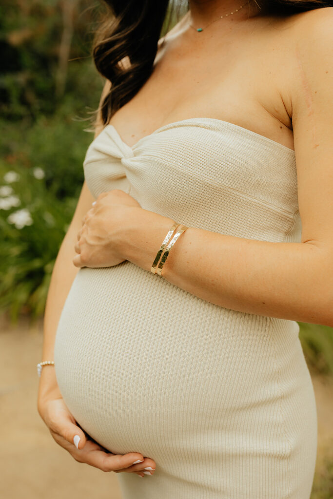Pregnant mother holding her belly for photoshoot