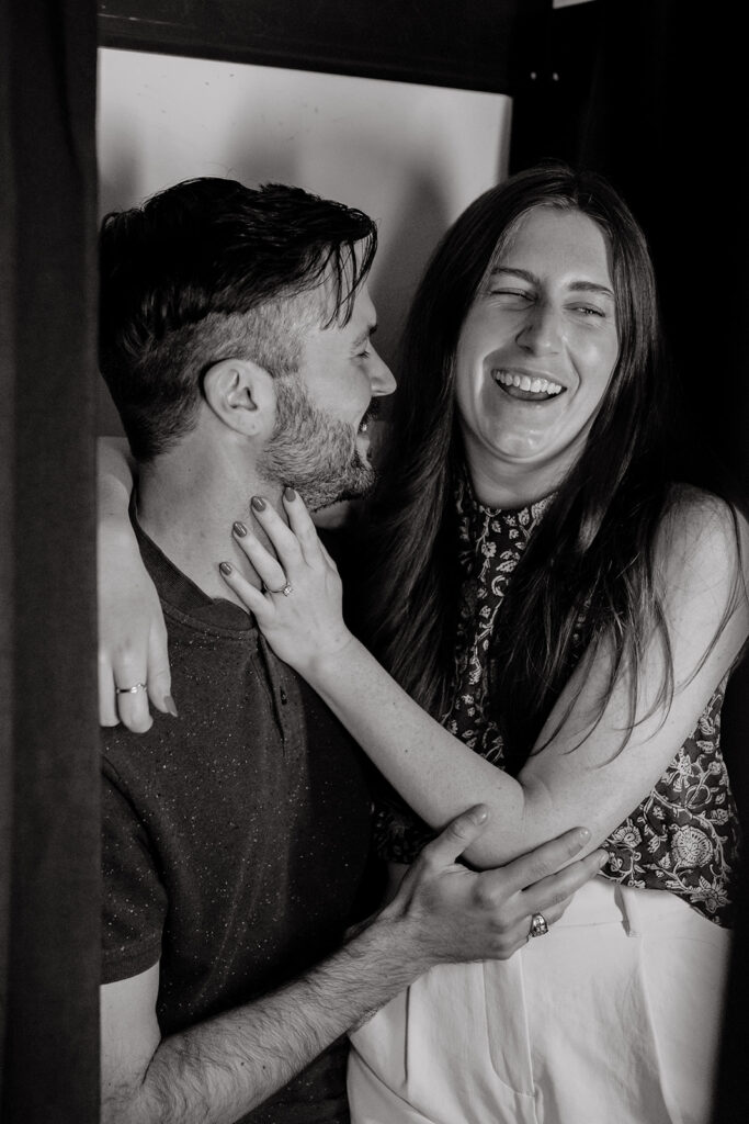 Couple posing for photos in photobooth