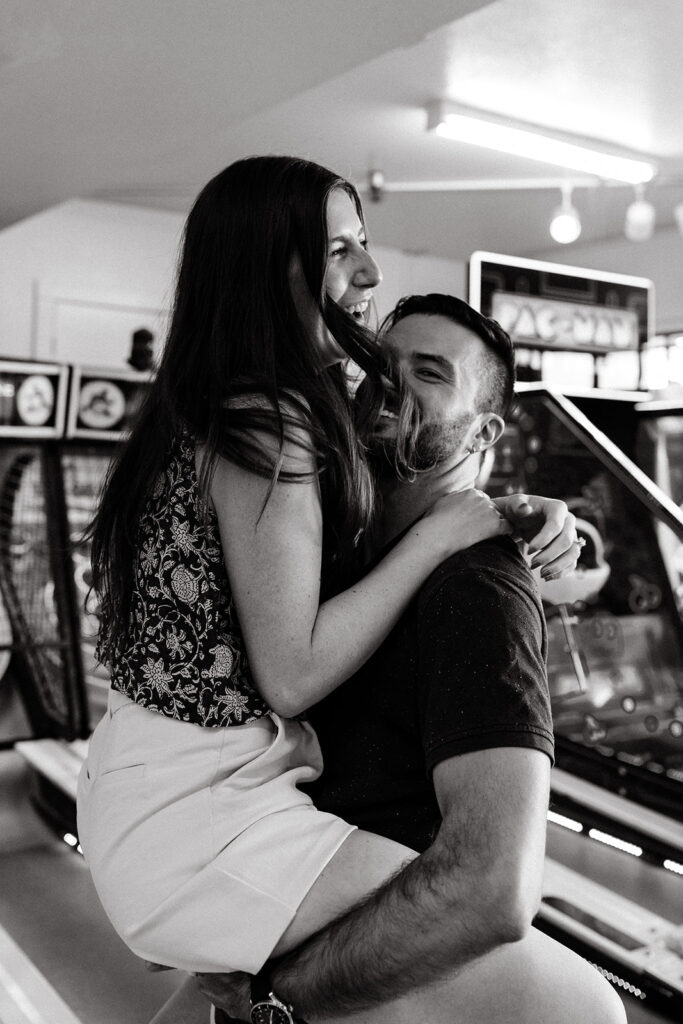 Couple playing skee ball at an arcade