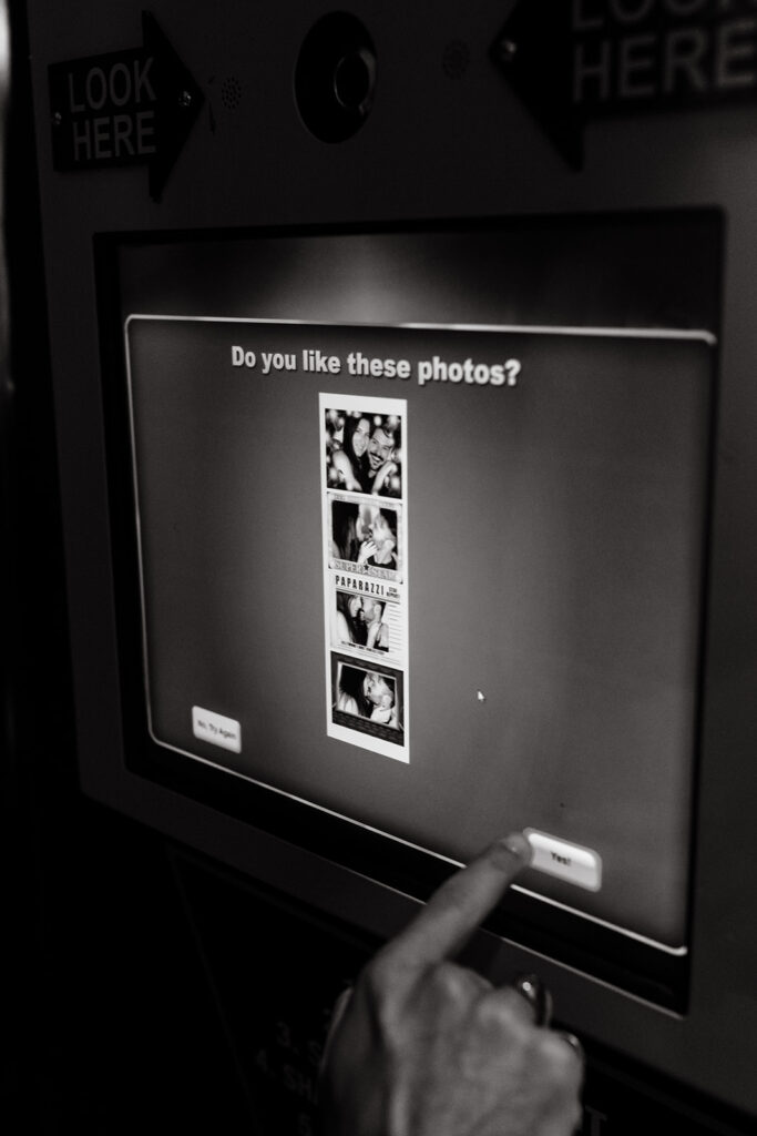 Couple posing for photos in photobooth