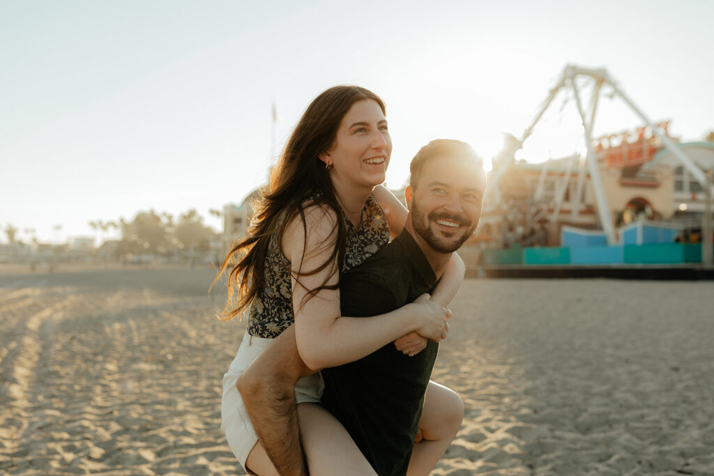 Couple running on the beach for Santa Cruz Beach engagement photos