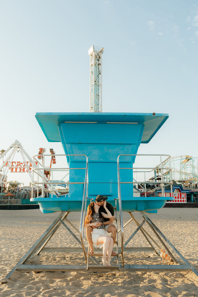 Couple posing on Santa Cruz beach for engagement session