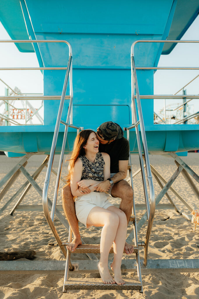 Couple posing on Santa Cruz beach for engagement session