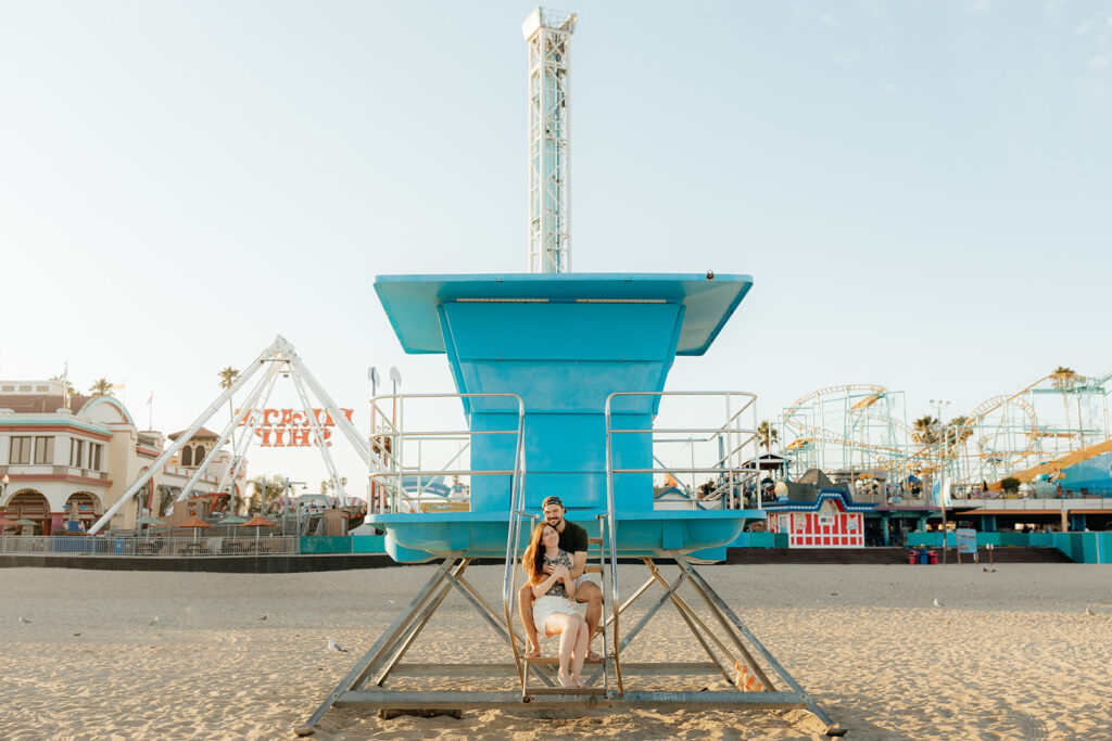 Couple posing on Santa Cruz beach for engagement session
