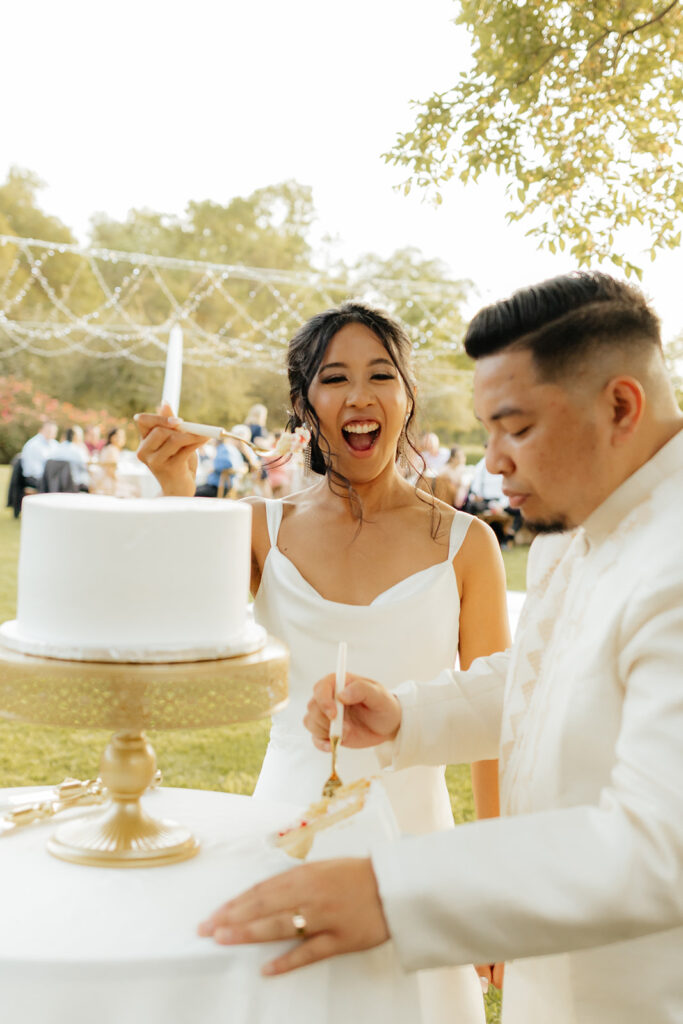 Bride and groom cutting wedding cake