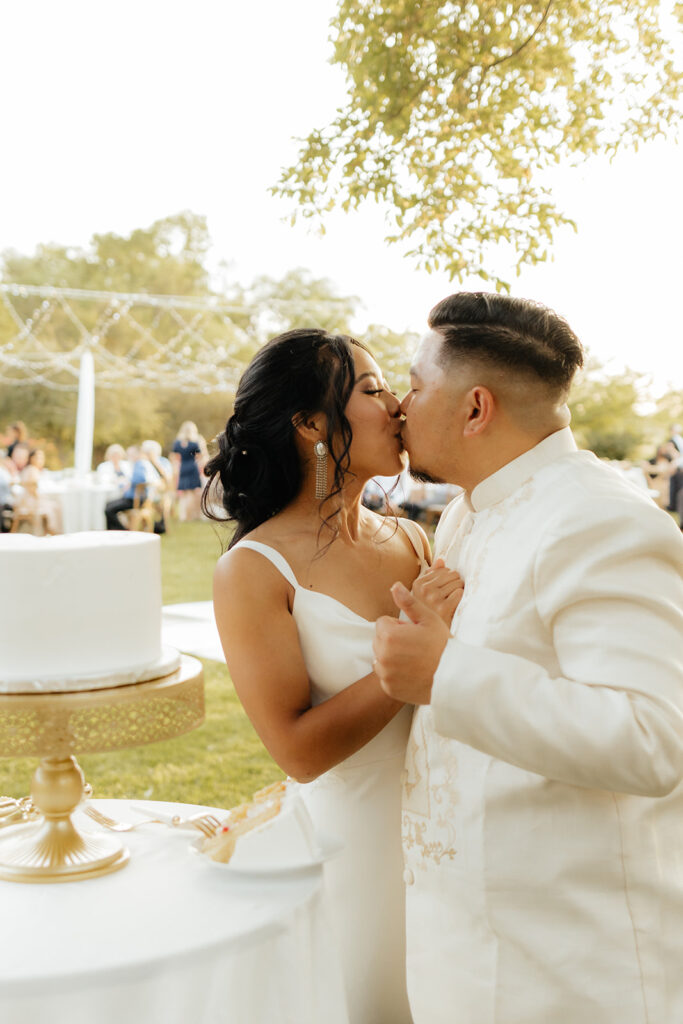 Bride and groom cutting wedding cake