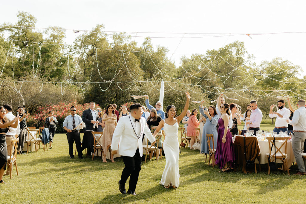 Bride and groom entering reception