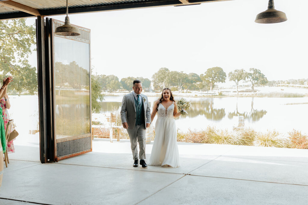 Bride and groom entering wedding reception