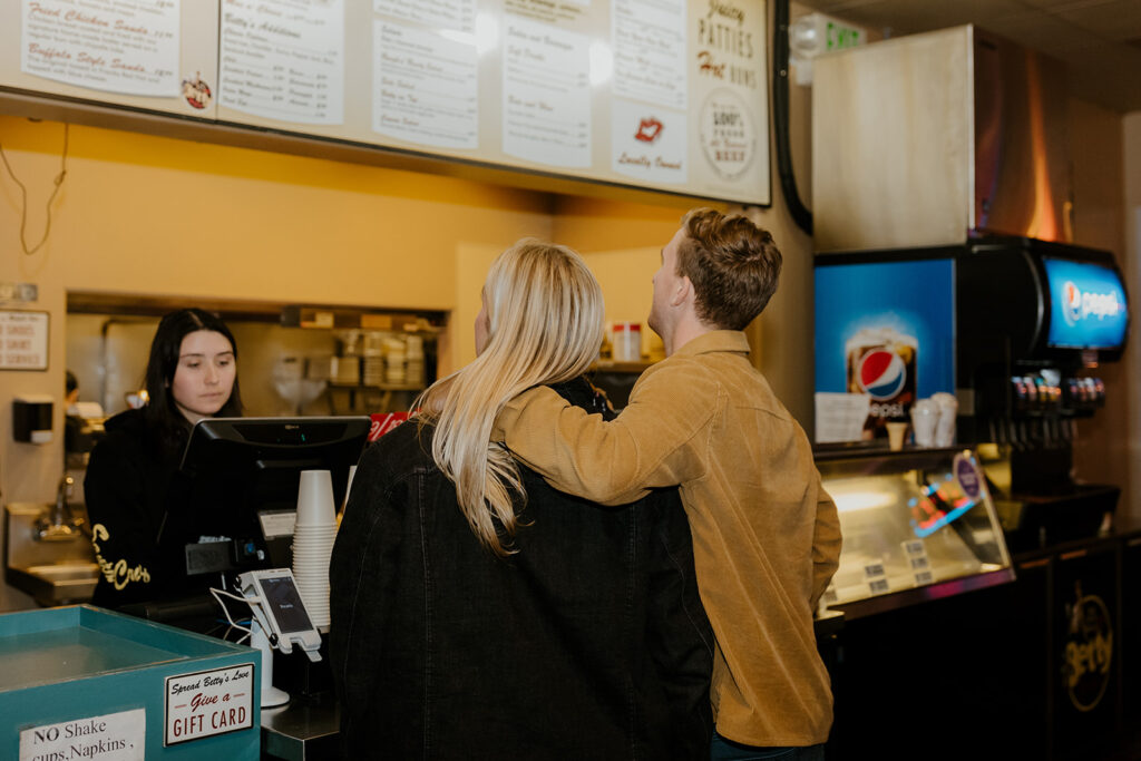 Playful couples photos at the original Betty's Burgers in Santa Cruz, CA