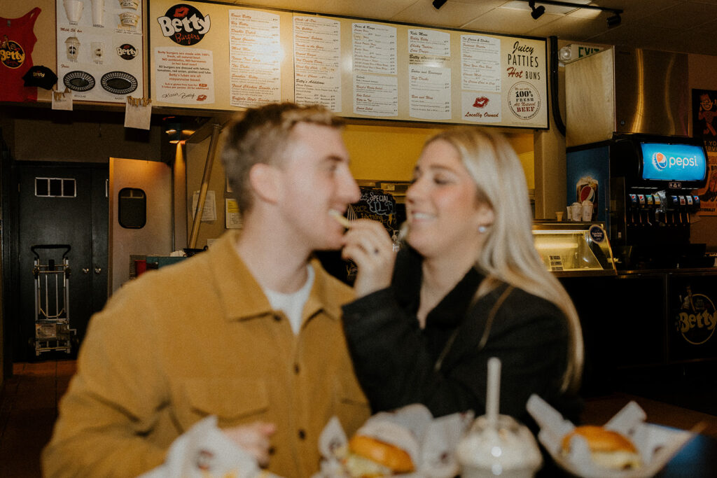 Playful couples photos at the original Betty's Burgers in Santa Cruz, CA