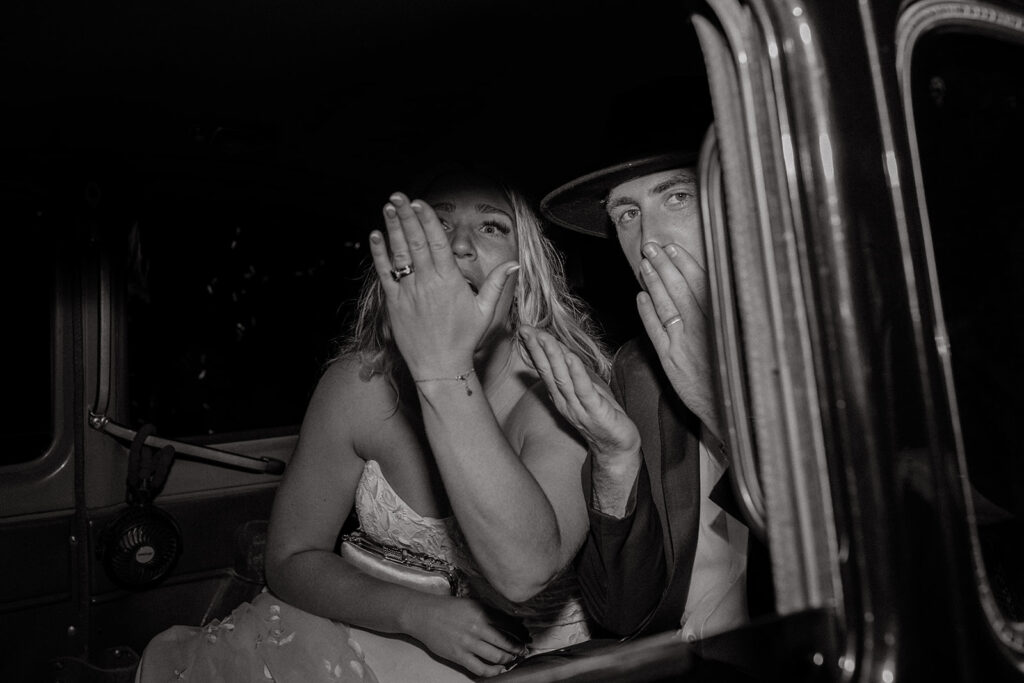 Bride and groom leaving wedding in vintage car
