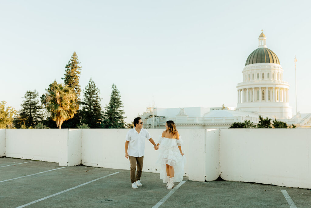 Playful couples rooftop downtown engagement photos in Sacramento